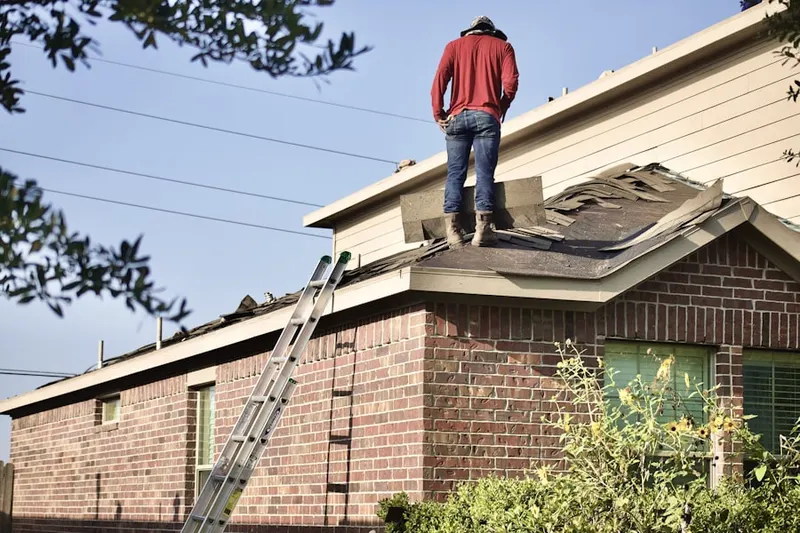 Professional roofer working on a residential roof in East Lake